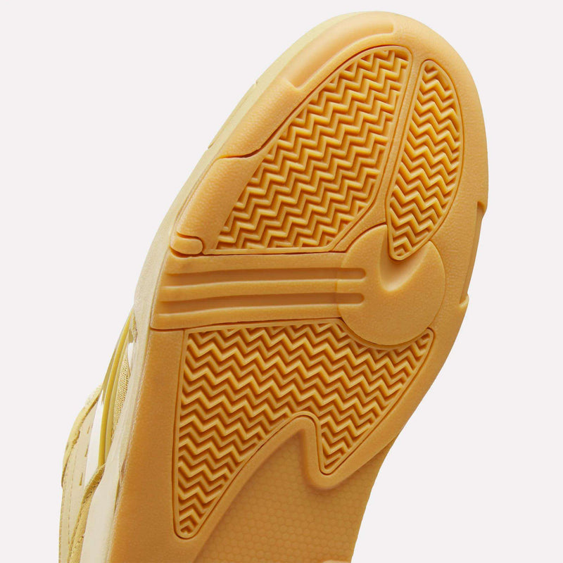 Yellow Reebok Omni Edge sneaker sole with a textured herringbone tread pattern and an EVA midsole.