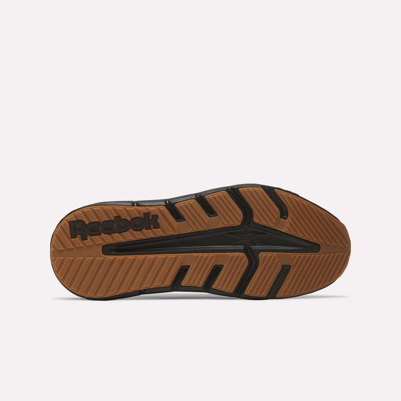 The image shows the sole of a Reebok Nano Gym 2.0 Training Shoe with a brown and black rubber tread, the Reebok logo near the heel, and angled grooves designed for grip and traction—ideal for versatile training sessions.