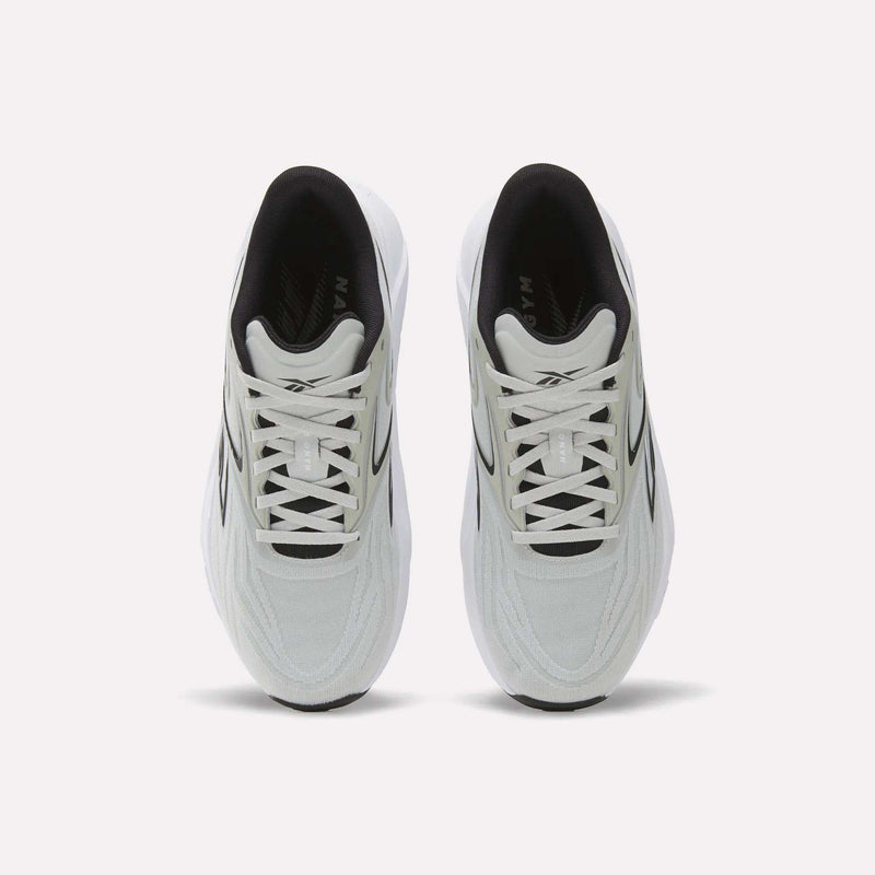 A top view of Reebok Nano Gym 2.0 Training Shoes shows a white pair with black accents, white laces, a slightly chunky silhouette, and a comfortable black interior.