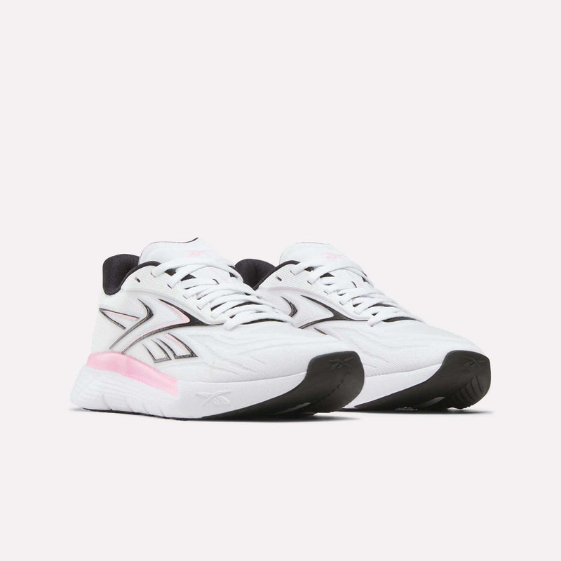 The Reebok Women's Nano Gym 2.0 Training Shoes feature a white design with black and pink accents, a thick sole, black outsole, and the signature logo on the side, shown on a plain white background.