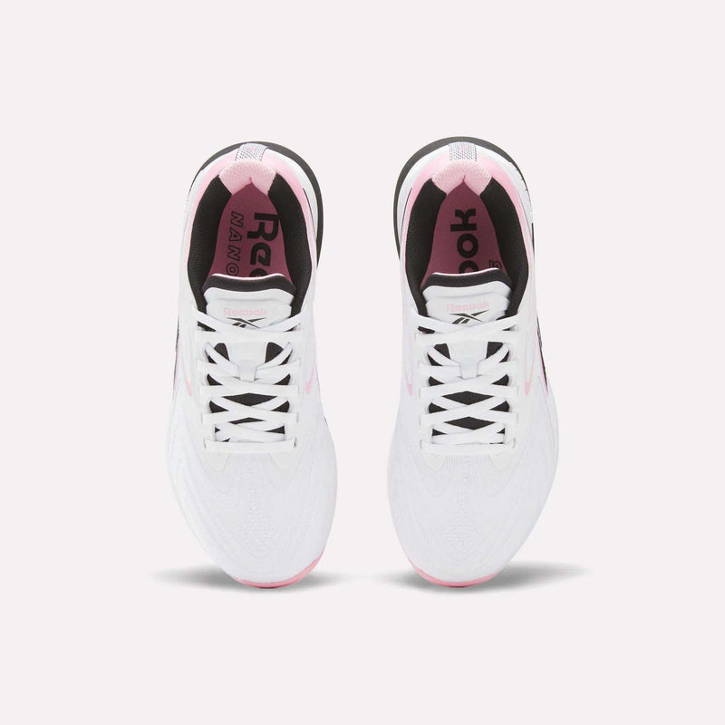 Top view of Reebok Women's Nano X5 Edge Training Shoes in white with pink accents, black inner lining, and visible laces, shown side by side on a light background.