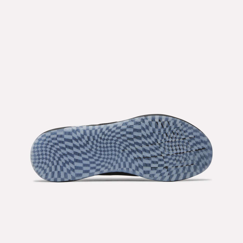 The image displays the sole of a Reebok Nano X5 Edge Training Shoe, featuring a blue and white checkered pattern reminiscent of an optical illusion. The tread showcases smooth, rounded grooves designed to enhance grip, emphasizing both performance and style.