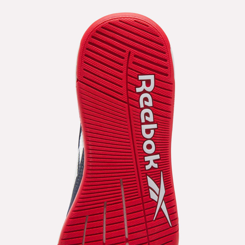 Close-up of the red sole of the Reebok Nano X5 Edge Training Shoes, displaying the white logo and diagonal grooves for traction. Designed with Flexweave technology, these shoes deliver enhanced grip and durability for training.