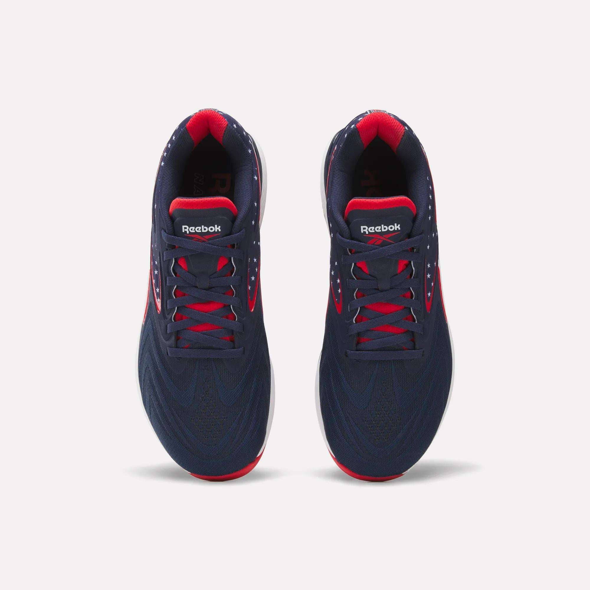 Top view of a pair of Reebok Nano X5 Edge Training Shoes in navy blue with red accents on the collar, sole, and lace holes, side by side on a white background.