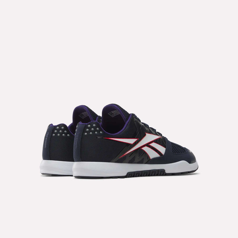 The Men’s Nano 2.0 Training Shoes by Reebok are black training shoes crafted for functional fitness, featuring white soles, red and white accents, and a purple inner lining. They are displayed from a rear-side perspective against a plain white background.