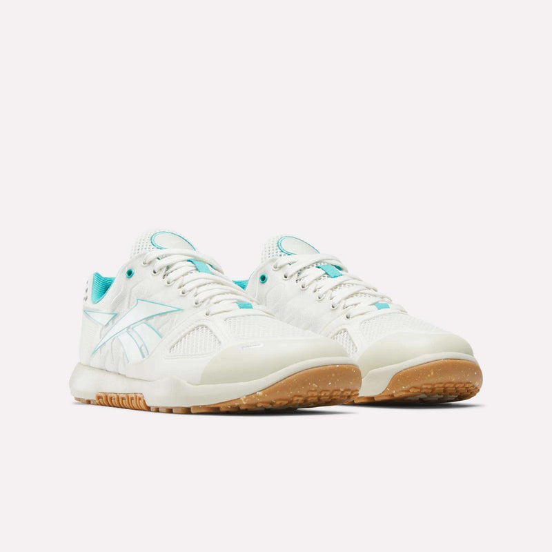 The Women’s Nano 2.0 Training Shoes by Reebok are showcased on a plain white background, featuring white uppers with teal accents and gum-colored soles—delivering an ideal blend of style and performance for functional fitness.