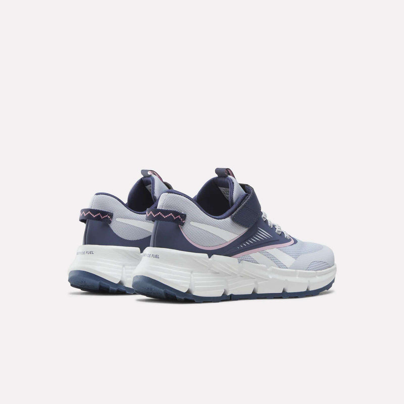 A pair of Reebok Zig Dynamica 6 Shoes for little kids in light purple and navy blue, featuring white chunky soles, mesh uppers, and zigzag stitching on the heel, designed as running shoes and displayed on a plain light background.