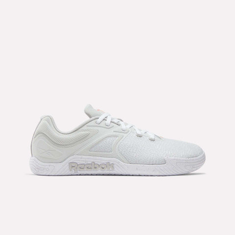 The Reebok Nano Zero Training Shoes are white athletic sneakers with mesh and textured accents, lace-up design, and the Reebok logo on the sole’s side. This zero-drop style is shown in a side profile against a plain background.
