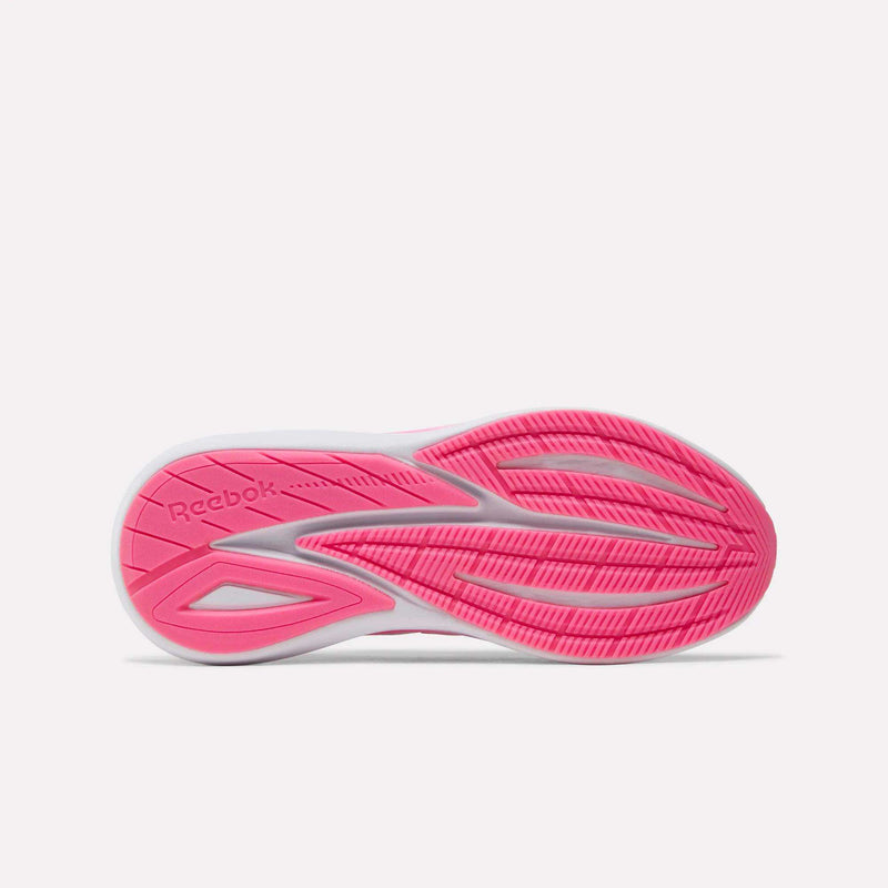The image features the bottom sole of the Women’s Viva Speed Shoes by Reebok, showcasing a mainly pink design with white accents and textured grooves for traction. Designed for comfort, the cushioned sole enhances each step, while the Reebok logo is displayed on the left side of the sole.