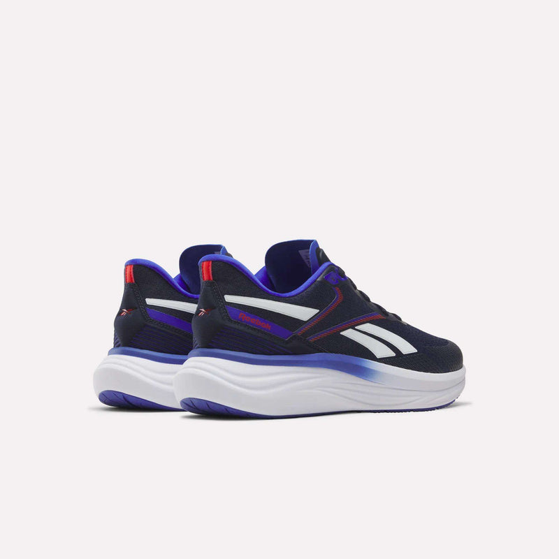 The Reebok Men's Viva Speed Shoes feature a black and white athletic design with striking blue and purple accents, thick white soles, and bold red highlights. Positioned on a light background facing away from each other, these sneakers provide breathable comfort and cushioned support, making them ideal for everyday wear.