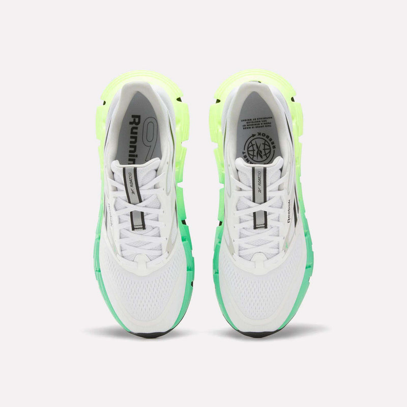 A top view of Reebok Men's FloatZig 2 Running Shoes in white with light green and neon yellow accents, Superfloat+ cushioning, black soles, and branding on the tongues and insoles, set against a plain white background.