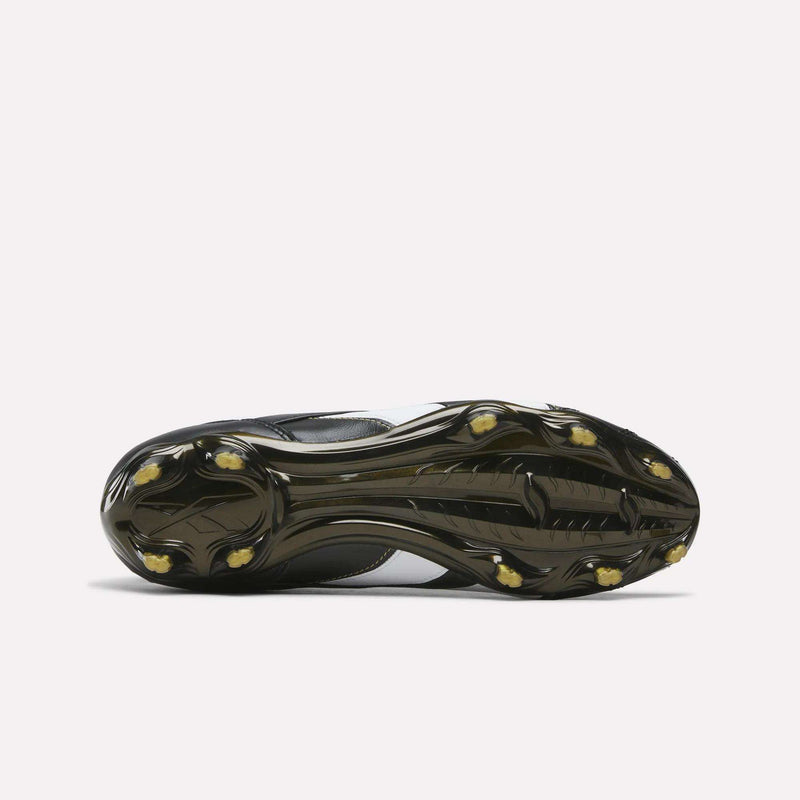 The sole of a black and white RBK800 Pro Firm Ground Soccer Cleat with dark molded studs.