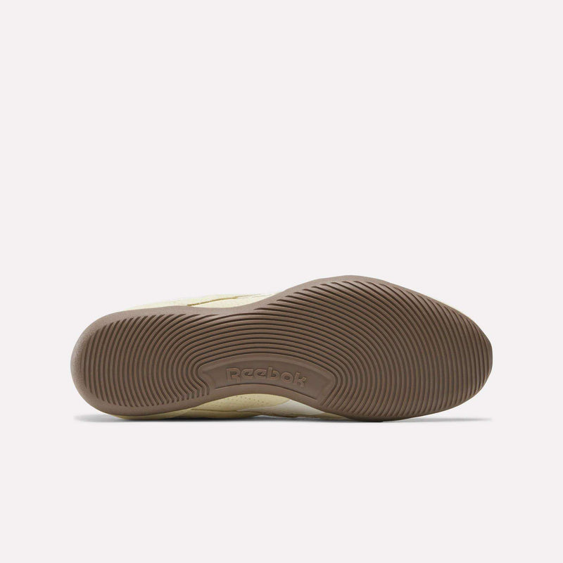 The image displays the brown, textured sole of the Reebok Women’s Ultra Lo Shoes laid on its side against a plain white background. The Reebok logo appears at the center of the sole, showcasing this stylish addition to their women’s sneaker collection.
