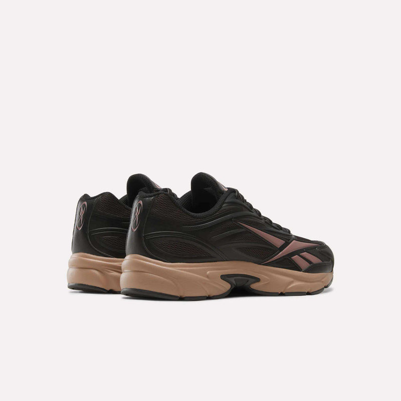 Rear view of black retro Reebok Premier Road 1000 Shoes with tan midsoles and pink side accents.