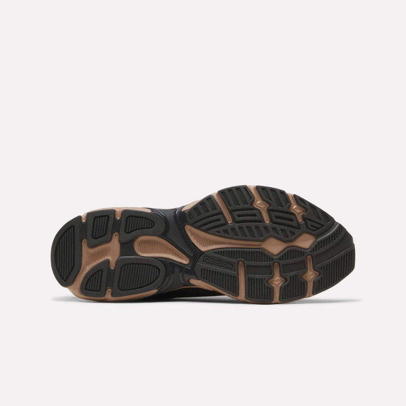 Bottom view of a Reebok Premier Road 1000 shoe featuring a black and tan treaded rubber sole.