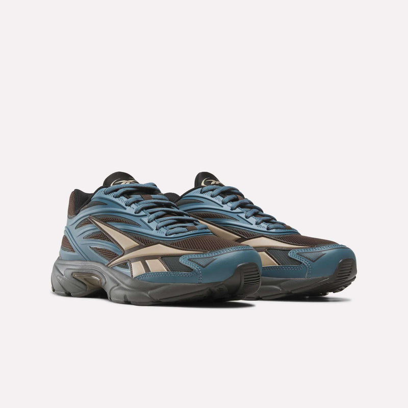 Blue and brown Reebok Premier Road 1000 Shoes with retro styling, mesh paneling, and a chunky dark grey sole.