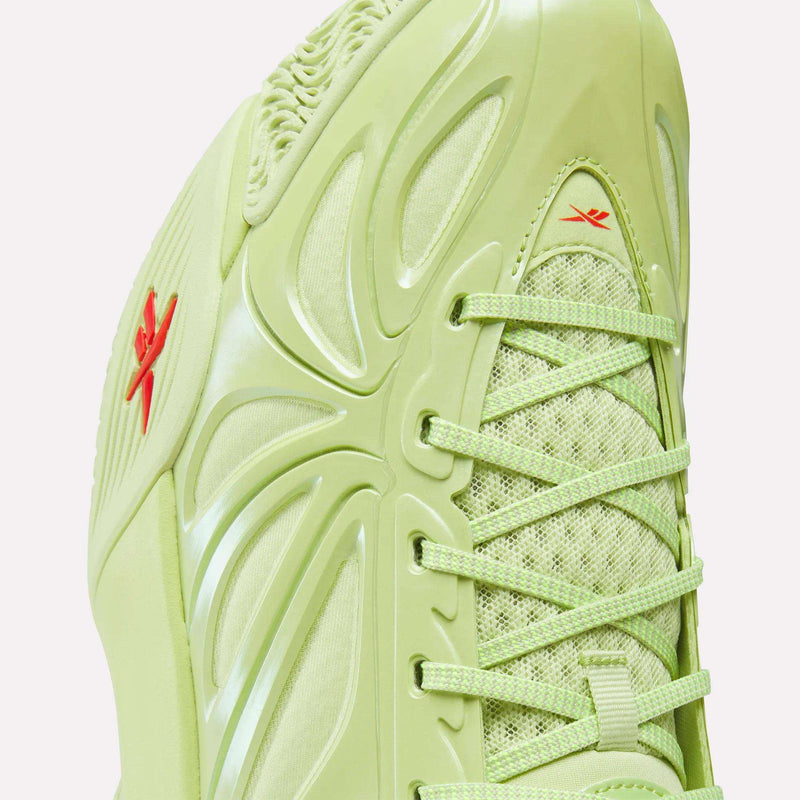 Close-up of the Reebok Angel Reese 1 Basketball Shoes in light green, with textured laces, mesh upper, glossy side panels, two small red Reebok logos, and Energy Return System technology inspired by Angel Reese.