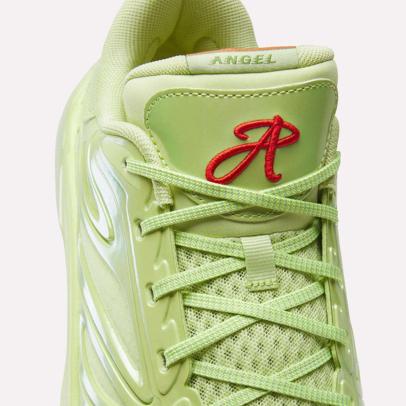 Close-up of a light green Reebok Angel Reese 1 Basketball Shoe with mesh, shiny details, green laces, and a red embroidered A and "ANGEL" on the tongue—highlighting its performance basketball shoe inspiration.