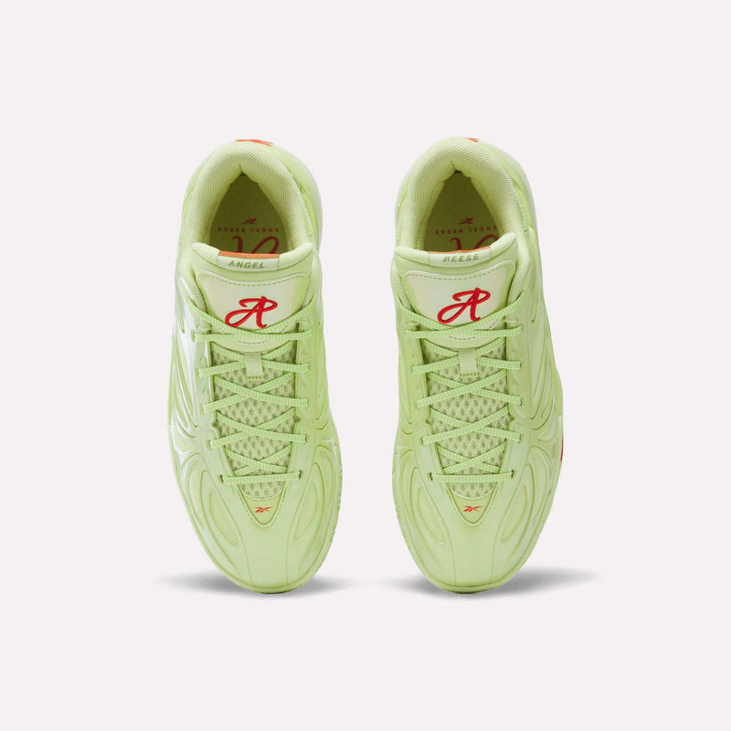 Top view of a pair of light green Reebok Angel Reese 1 Basketball Shoes with red R and logo on the tongues, white soles, patterned mesh uppers, and Reebok Energy Return System tech displayed against a white background.