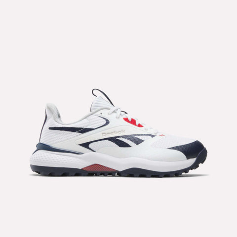 The Reebok Nano Golf Shoes are white athletic sneakers with navy blue and red accents, featuring a low-top design, mesh and synthetic upper with lightweight FlexWeave, and the signature Reebok logo on the side.