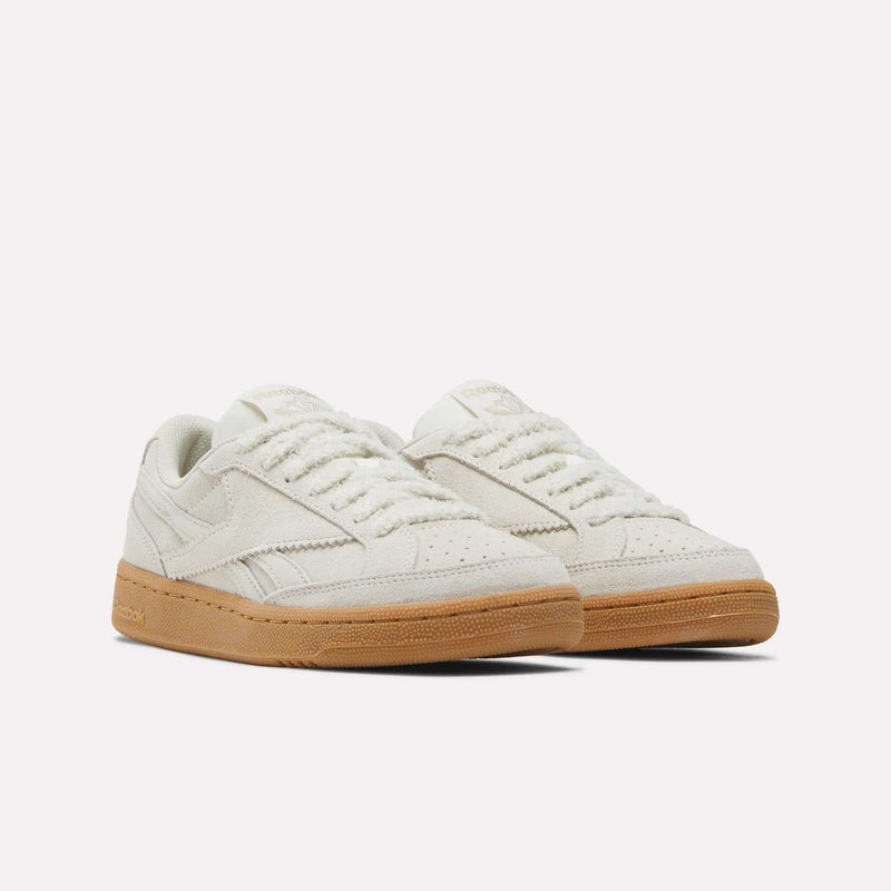A pair of Women’s Club C Grounds 70 Shoes by Reebok, featuring off-white textured suede uppers and gum rubber soles, displayed on a plain white background.