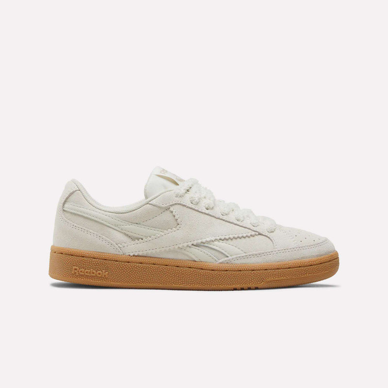 Experience timeless retro style with the Reebok Women’s Club C Grounds 70 Shoes, shown here in a Chalk/Linen/Gum colorway featuring a suede upper, crisp white laces, and a light brown gum sole—an iconic choice for classic sneaker fans.