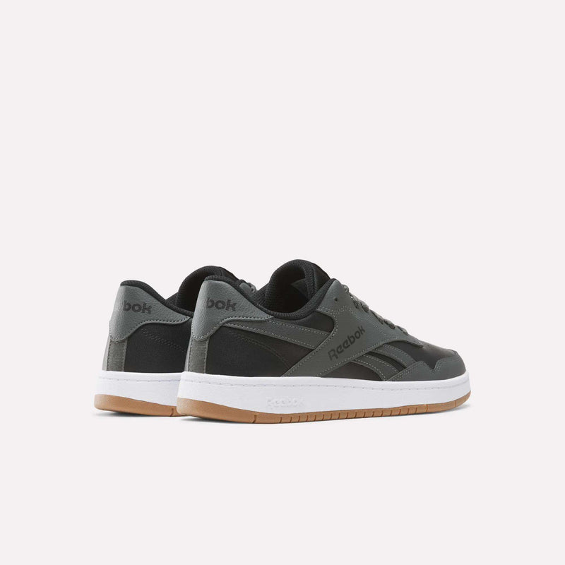 A pair of Reebok Men’s BB 1000 Shoes in dark gray, showcasing classic side-stripe detailing, white midsoles, and gum rubber outsoles, displayed from the side and back on a plain white background.