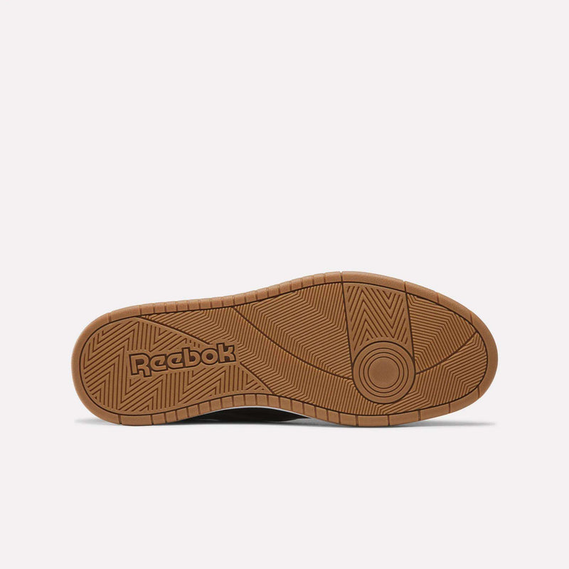 Brown rubber sneaker sole featuring geometric tread patterns and the Reebok logo embossed on the heel area, showcased on a white background—an essential element of the Reebok Men’s BB 1000 Shoes, offering dependable traction and lasting comfort for both basketball and everyday wear.