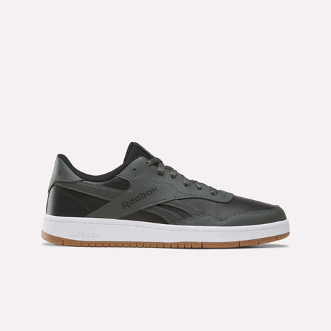 An espresso-colored Reebok Men’s BB 1000 Shoe, featuring a classic side-stripe, white midsole, and gum rubber outsole, is shown in a side profile view on a plain white background.
