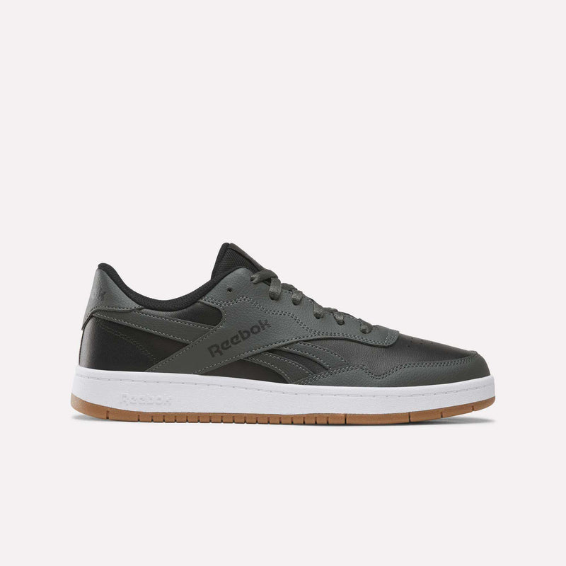 An espresso-colored Reebok Men’s BB 1000 Shoe, featuring a classic side-stripe, white midsole, and gum rubber outsole, is shown in a side profile view on a plain white background.