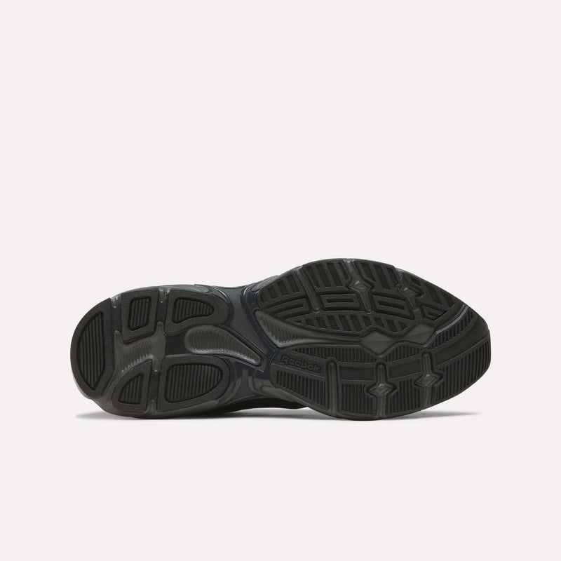 The black rubber outsole of the Reebok Premier Road 1000 Shoes is displayed from the bottom, showcasing retro running tread patterns and textured grip areas against a plain white background.