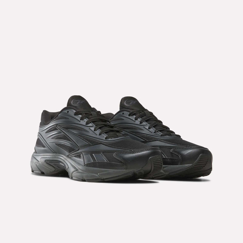 The Reebok Premier Road 1000 Shoes, featuring a black colorway with textured detailing and chunky EVA midsoles inspired by vintage running styles, are showcased against a plain white background.
