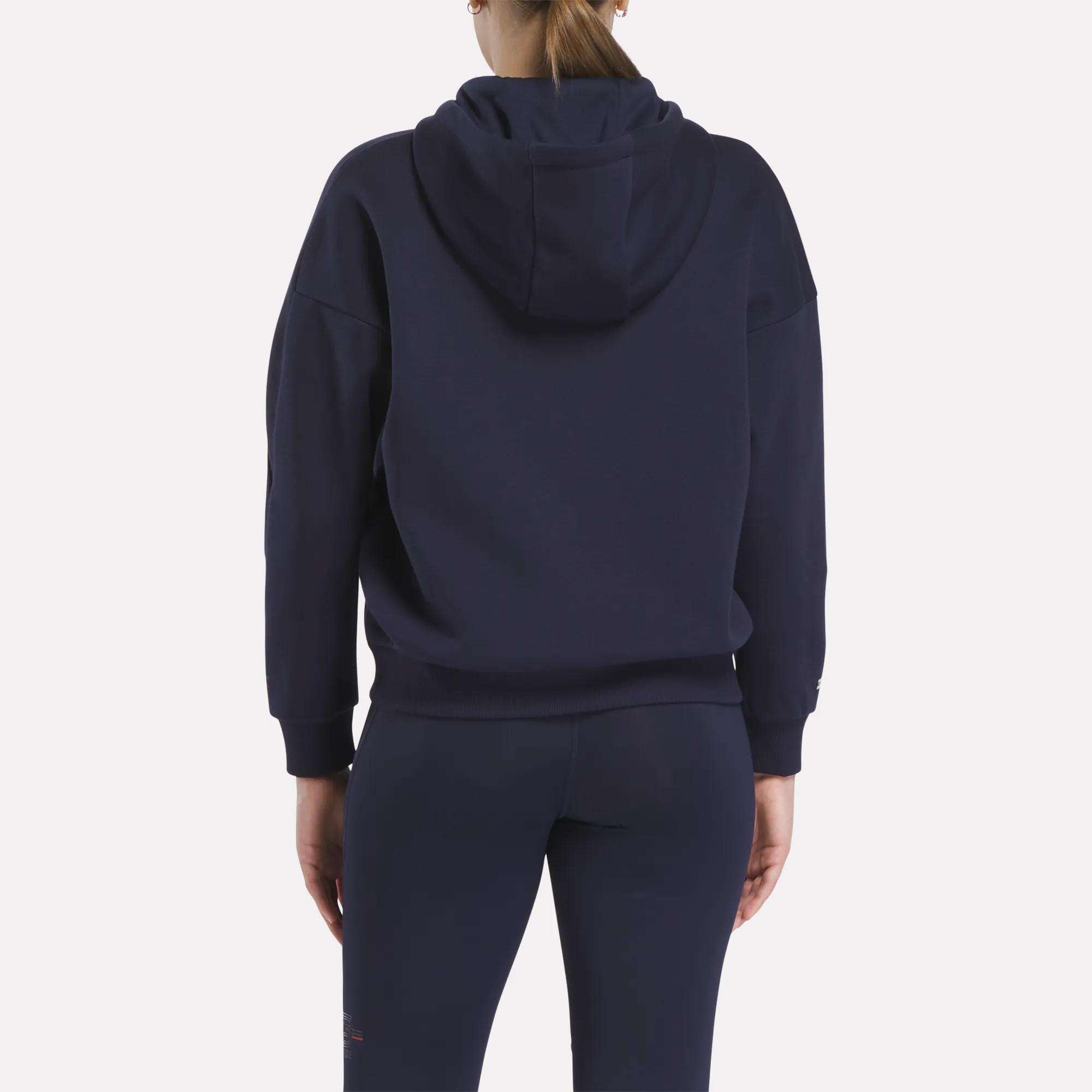 A person is shown from the back wearing a navy Women's Reebok x F45 Coach Full-Zip Hoodie against a plain light background.