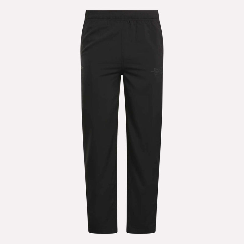 The Men's Reebok x F45 Training Woven Pants feature an elastic waistband, straight legs, and subtle stitching details, designed by Reebok for optimal performance during high-intensity training sessions. They are shown against a plain white background.