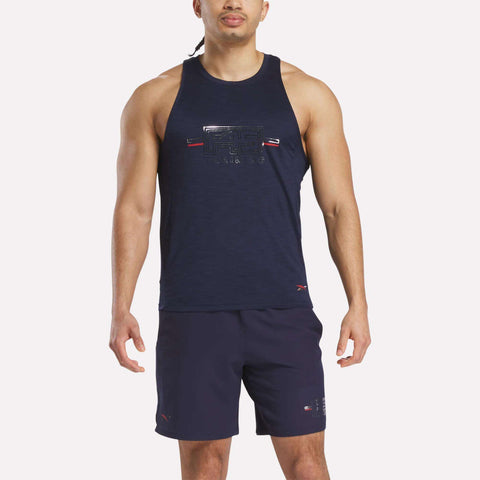 A man wearing the Reebok x F45 Training Coach Tank Top and matching navy shorts stands facing forward against a light background, ready for an intense workout.
