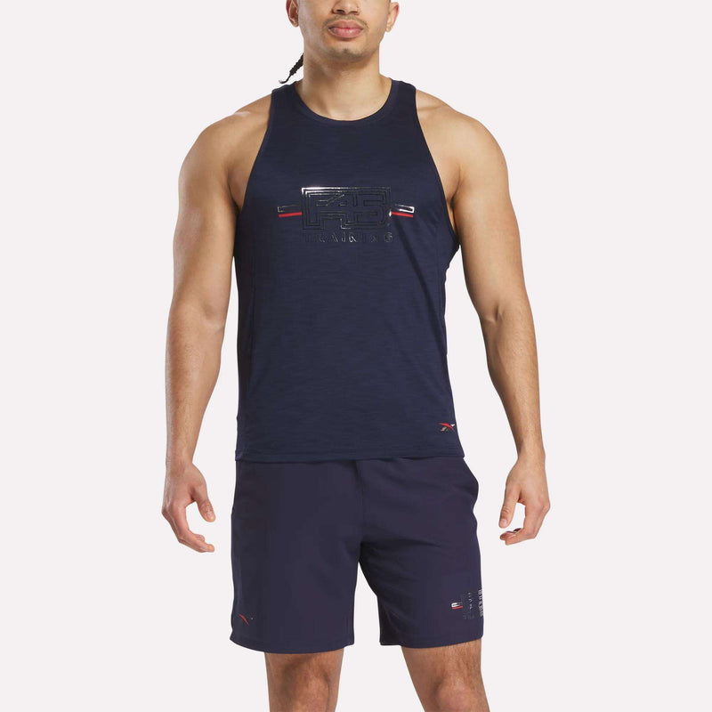A man wearing the Reebok x F45 Training Coach Tank Top and matching navy shorts stands facing forward against a light background, ready for an intense workout.