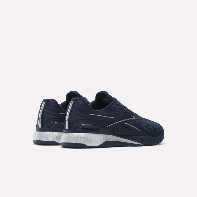 The Reebok Nano X5 Edge F45 Shoes feature navy blue with white and silver accents, displayed from the back and side on a light background. Ideal for F45 workouts and high-intensity training.