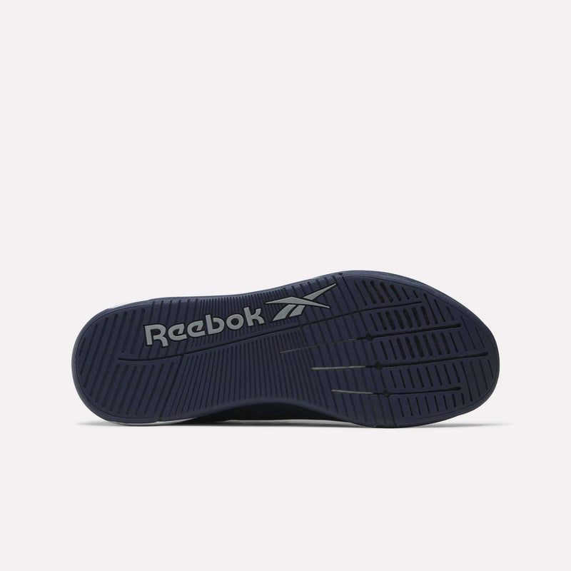 The image displays the dark blue sole of the Reebok Nano X5 Edge F45 Shoes, shown from below, with a light gray Reebok logo at the center and textured grooves for traction during F45 workouts.