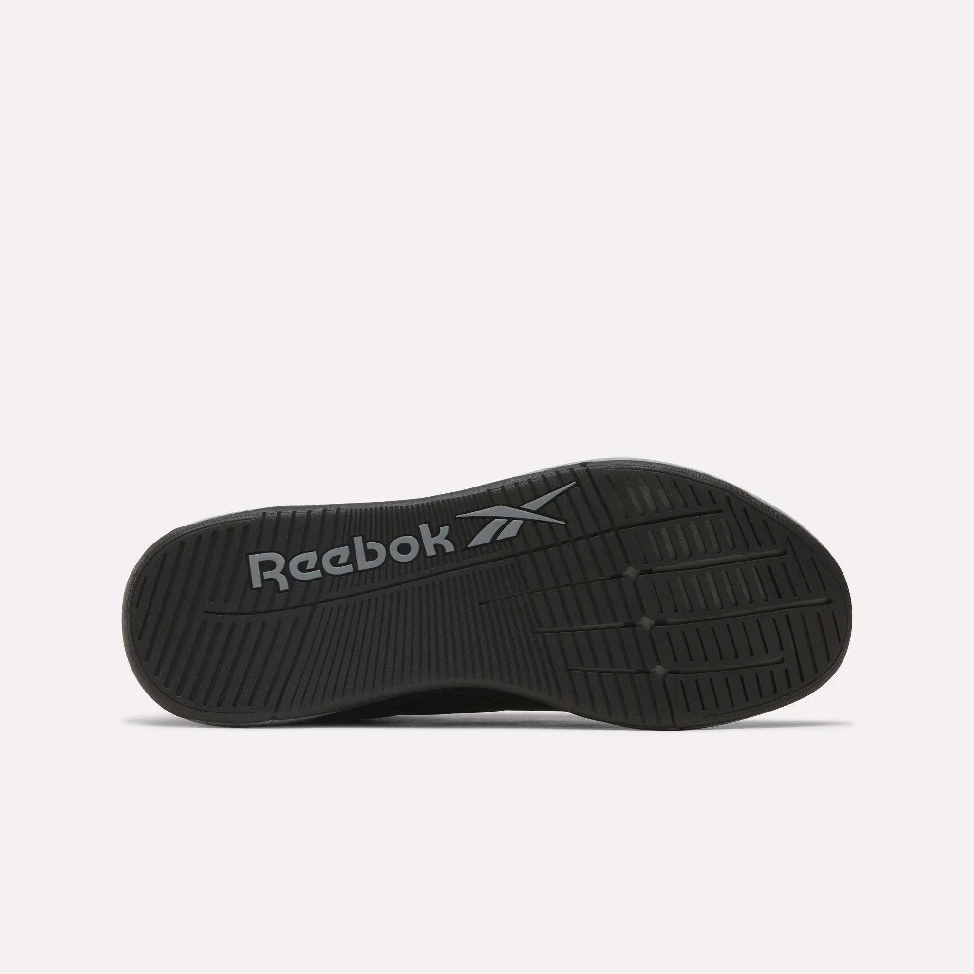 The Reebok x F45 Nano X5 Edge shoes feature a black rubber outsole with the Reebok logo and multiple tread patterns, enhancing grip during training.