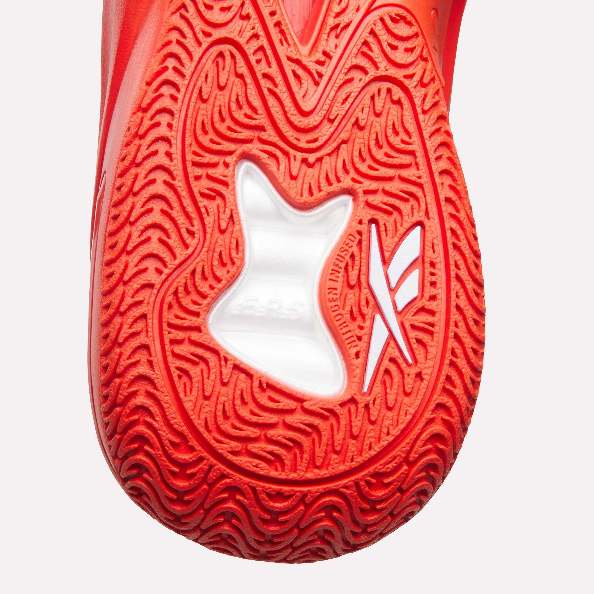 Close-up of the red textured sole of the Reebok Angel Reese 1 Basketball Shoes, featuring a white star-shaped cutout and stylized markings, and highlighting the Energy Return System for optimal support.