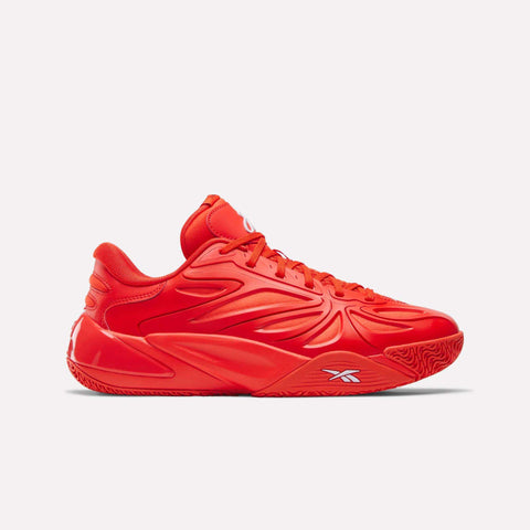 The Angel Reese 1 Basketball Shoes by Reebok are bright red with a sleek, sculpted design, textured sole featuring the Energy Return System, and a bold Reebok logo on the midsole, shown in side profile against a plain white background.