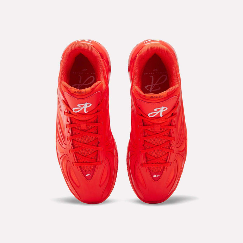 Top view of bright red Angel Reese 1 Basketball Shoes by Reebok, with wavy patterns, red laces, white R logo on the tongue, and Energy Return System, set against a plain white background.