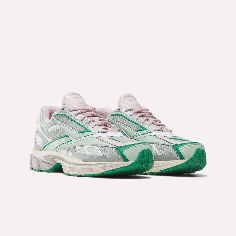 A pair of Reebok Premier Road Ultra SV Shoes—a Y2K-inspired running sneaker—showcased on a plain white background, featuring mesh and leather panels in white, light pink, gray, and green accents, with green soles and lace-up fronts.