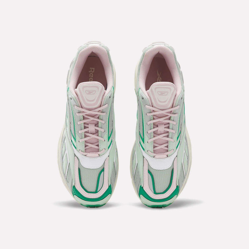 A pair of Reebok Premier Road Ultra SV Shoes seen from above, showcasing white mesh uppers, light pink accents, and green side and toe details, complete with pink laces and a chunky sole inspired by classic Y2K sneaker design.