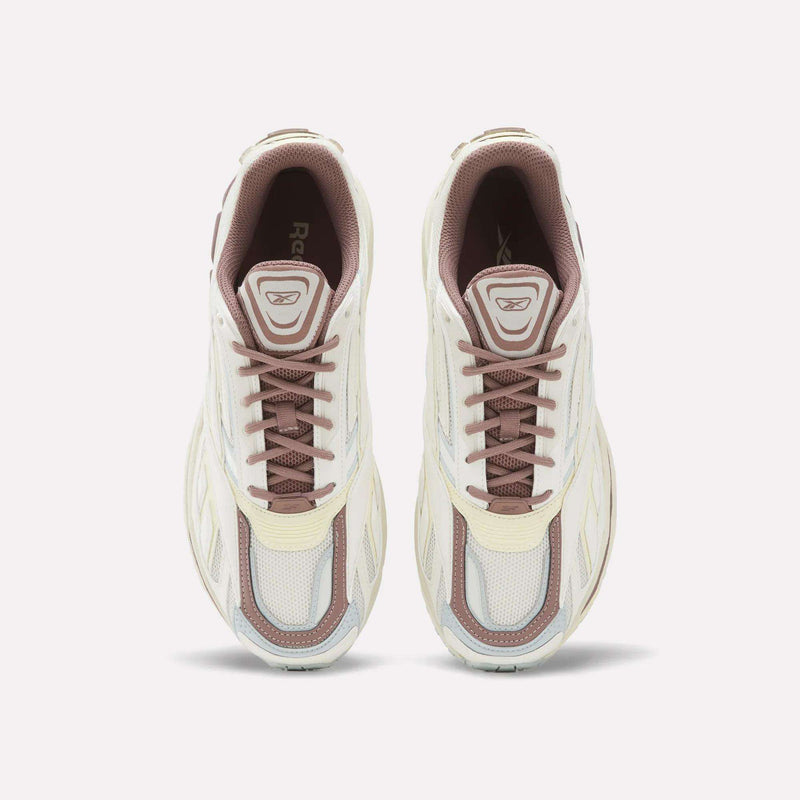 A top-down view of a pair of Reebok Premier Road Ultra SV Shoes in white and beige with brown laces, placed side by side on a plain white background.