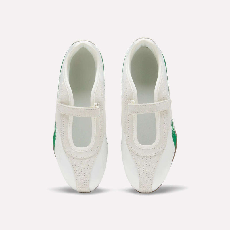 A top view of a pair of Women’s Ultra Lo Mary Jane Shoes by Reebok, in white with green accents and velcro straps, featuring a satin upper, placed side by side on a plain light background.