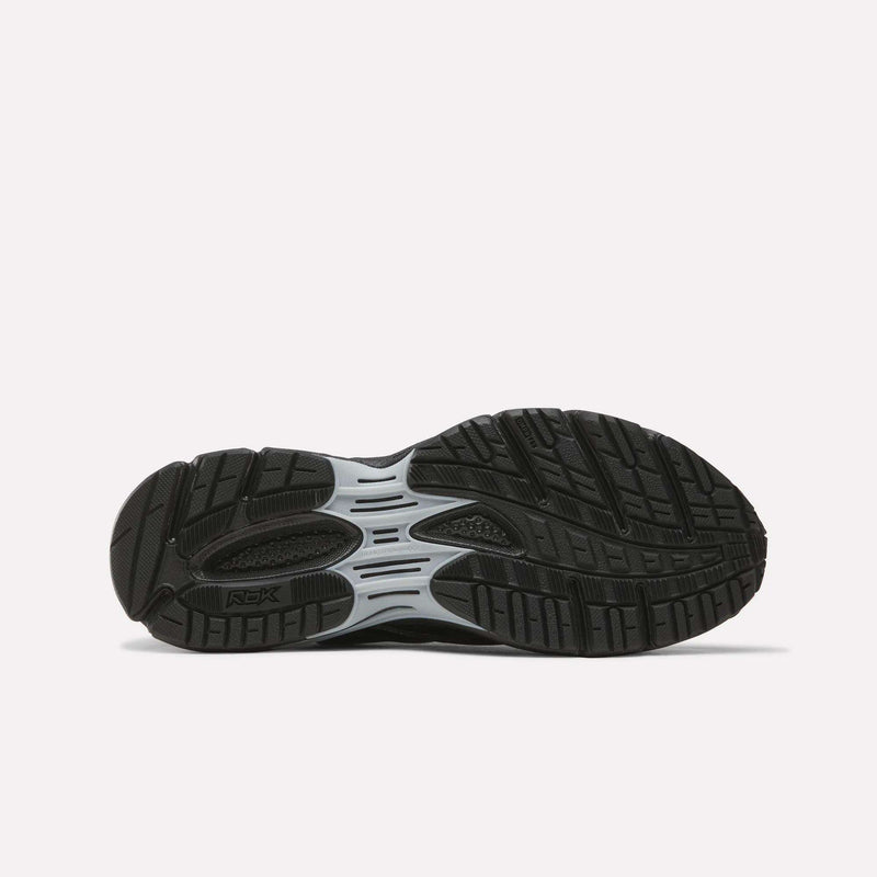 The image displays the black rubber outsole of a Reebok Premier Road Ultra SV Shoe, highlighted by a gray midsection and detailed with textured grooves and patterns for enhanced traction. The shoe is positioned sole up on a plain white background.
