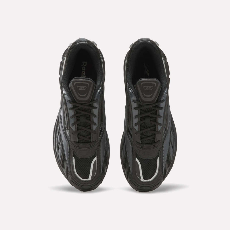 Top view of a pair of black Reebok Premier Road Ultra SV athletic running sneakers with gray and white accents, laces tied, placed side by side on a plain white background. These shoes showcase classic style and comfort.