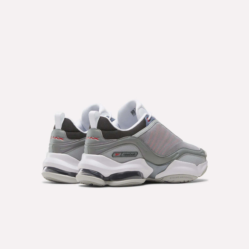 A pair of gray and white Reebok DMX Series 3000 Shoes with mesh uppers, thick white soles, and visible air cushioning are viewed from the back and side against a plain white background, combining classic comfort.