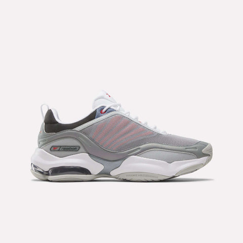 The Reebok DMX Series 3000 Shoes in Grey/White/Red feature mesh panels, white laces, a visible air-cushioned sole with DMX moving air technology for enhanced comfort, and subtle red accents. They are displayed on a plain white background.